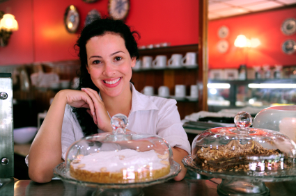 owner of a small business store showing her tasty cakes